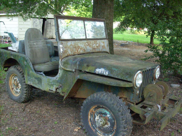 1946 Jeep CJ5 with winch, rusty green paint, 3/4 front view
