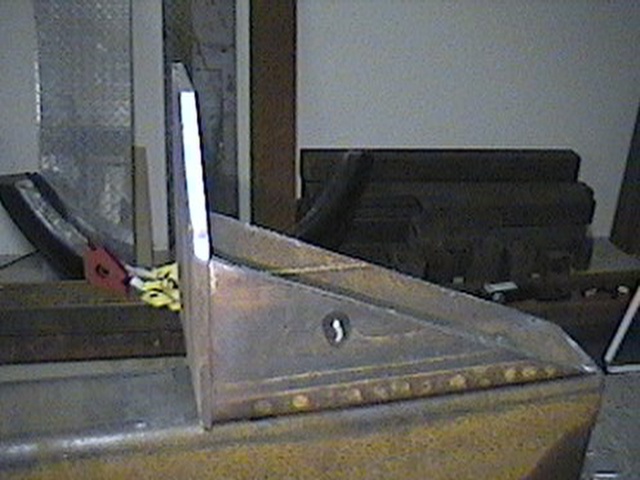 Fabricated metal corner piece with rivets and a keyhole