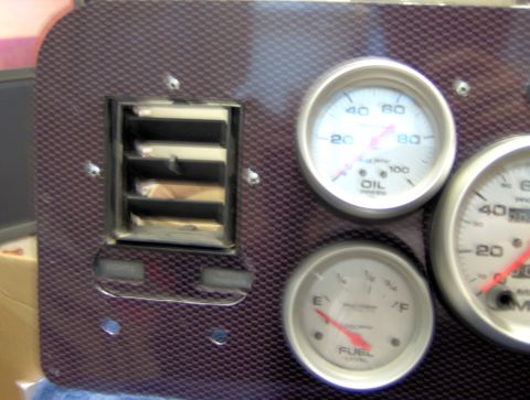 1978 Ford Bronco - Close-up of a custom dashboard oil pressure and fuel level gauges, along with an air vent.