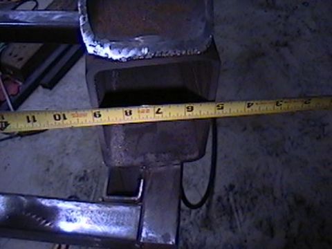 1992 Ford Bronco - Close-up of a metal bracket with a tape measure indicating a measurement.