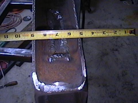 1992 Ford Bronco - A close-up view of a fabricated metal part being measured with a yellow tape measure.