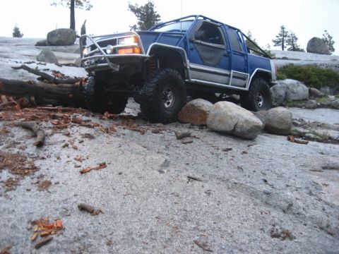 1989 Ford Bronco - Modified 1989 Ford Bronco navigating a challenging rocky trail during an off-road excursion.