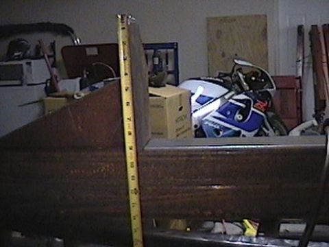 1992 Ford Bronco - A motorcycle is parked in a garage, partially obscured by a metal fabrication project.