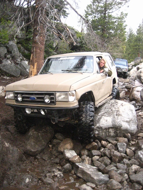 1989 Ford Bronco - This 1989 Ford Bronco is tackling a challenging rocky trail, with a second vehicle following.
