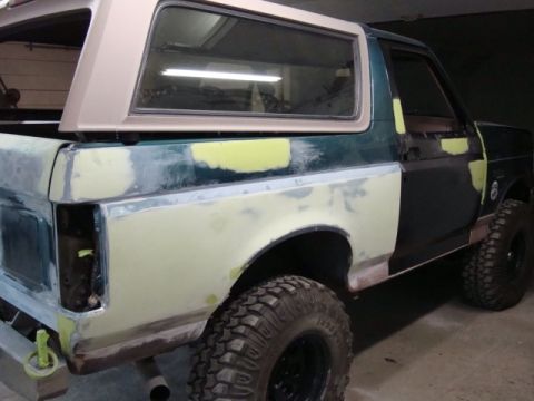 1996 Ford Bronco - Photograph of a Bronco undergoing bodywork with panels in primer, not a technical document.