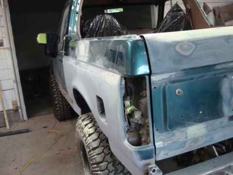 1996 Ford Bronco - Photograph of a Bronco rear corner in primer during bodywork, not a technical document.