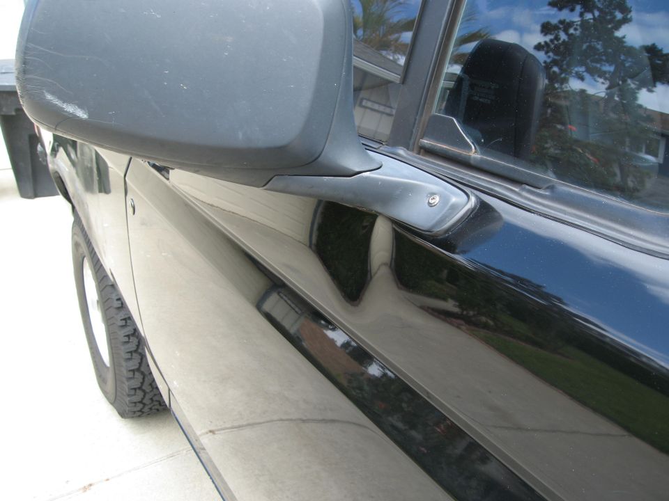 Black SUV driver's side door and side mirror