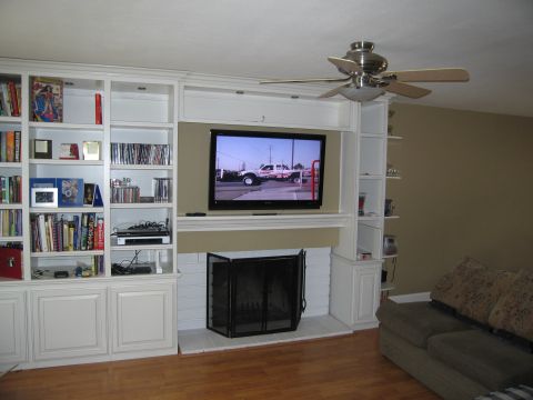 1986 Ford Bronco - A living room with a large built-in entertainment center and fireplace.
