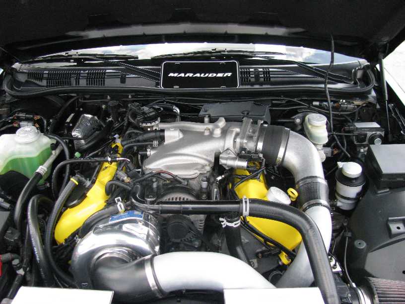 2003 Mercury Marauder engine bay with supercharger and yellow parts