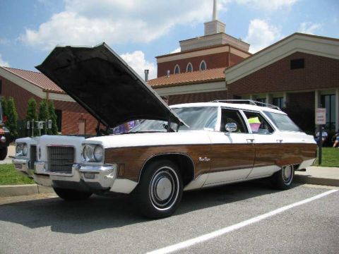 2003 Mercury Marauder - Station wagon with wood paneling and hood up, parked in a lot.