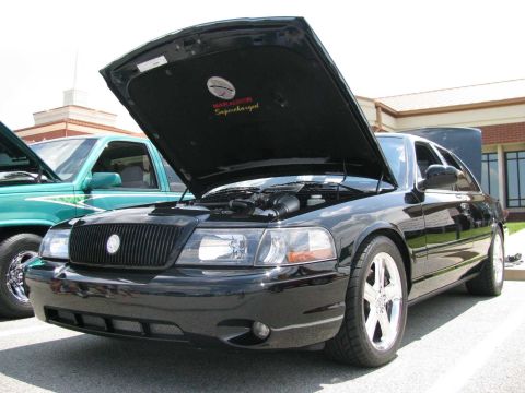 2003 Mercury Marauder - Front 3/4 view of a black 2003 Mercury Marauder at a car show, hood open.