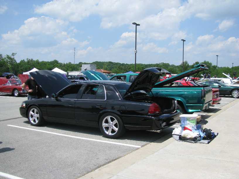 2003 Mercury Marauder parked with hood and trunk open at a car show, other vehicles visible