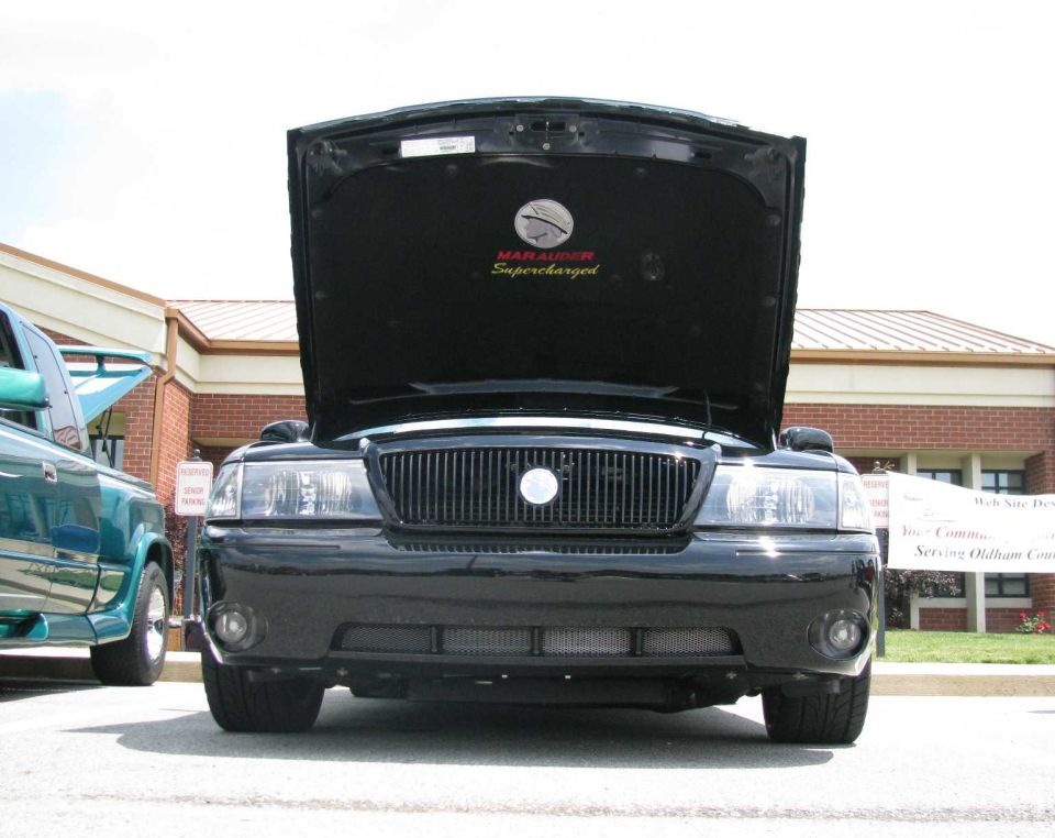 Black 2003 Mercury Marauder front view, hood open, showing "Marauder Supercharged" emblem
