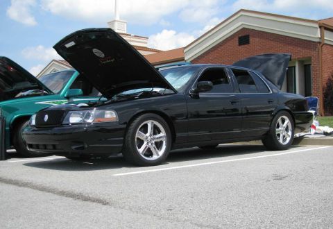2003 Mercury Marauder - A black 2003 Mercury Marauder is parked with its hood and trunk open, alongside another vehicle.
