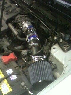 2002 Nissan SE-R - Aftermarket air intake system installed in the engine bay of a vehicle.