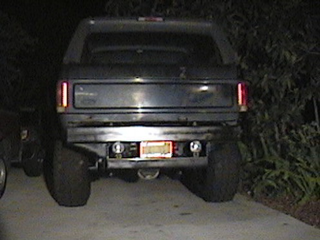 Dark SUV rear view with license plate and tow hitch