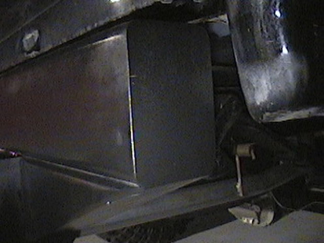 Underside of a vehicle, showing frame and some components. Watermark says SUPERMOTORS.NET