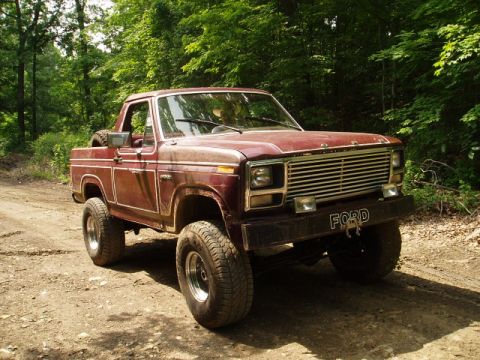 1980 Ford Bronco - This 1980 Ford Bronco features a prominent front grille and bumper with the 'FORD' nameplate visible.
