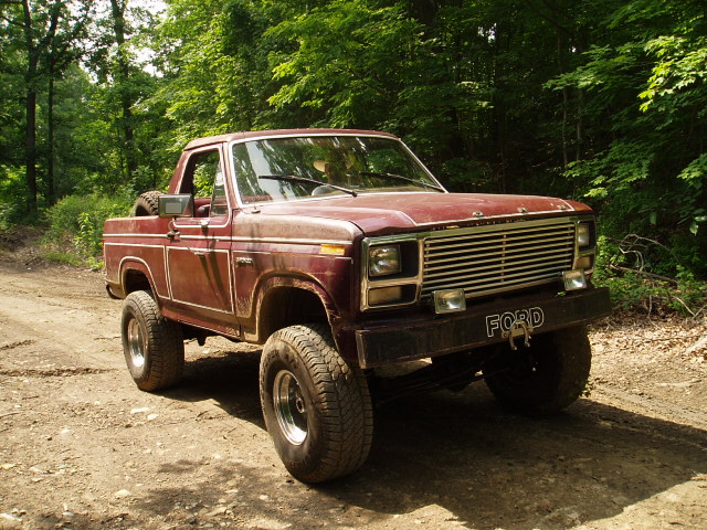 Red 1980 Ford Bronco front grille and bumper with 'FORD' text
