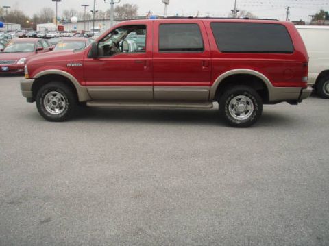 2003 Ford Excursion - Side view of a red 2003 Ford Excursion SUV with tan lower body trim and tinted windows.