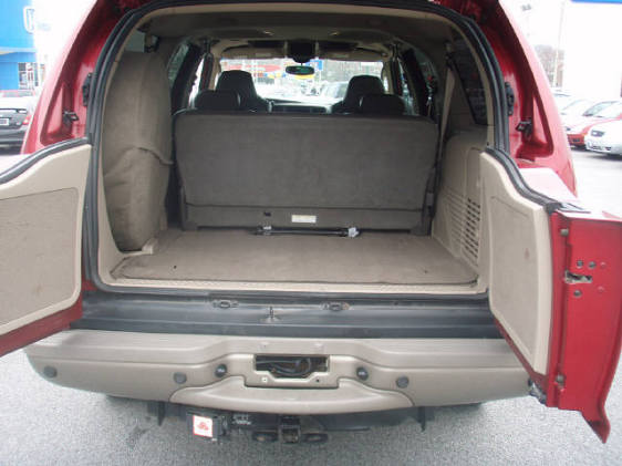 Red SUV interior with open hatch and folded rear seats