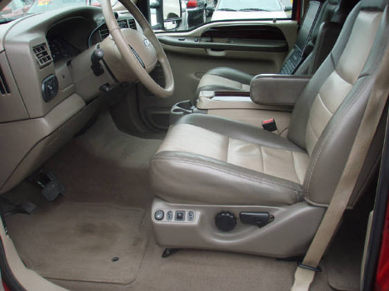2003 Ford Excursion interior showing front seats, dashboard, and steering wheel