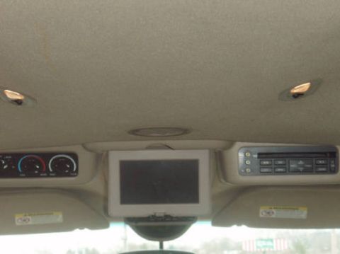 2003 Ford Excursion - Interior view of a vehicle's overhead console, showing entertainment and climate control features.