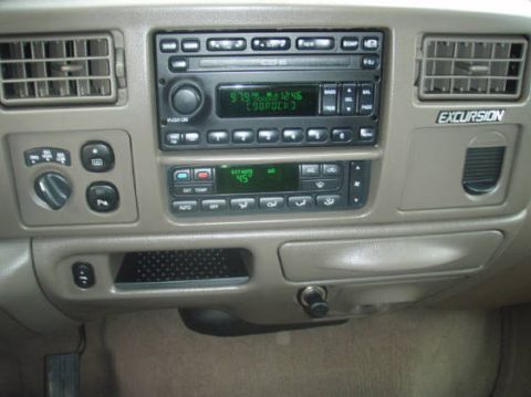 2003 Ford Excursion - Interior view of a 2003 Ford Excursion dashboard with the radio and climate control system visible.