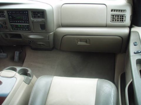 2003 Ford Excursion - The dashboard and center console of a 2003 Ford Excursion are visible in this interior photo.