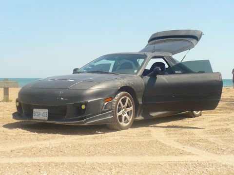 1993 Ford Probe - This 1993 Ford Probe is shown with its doors and rear hatch open on a beach.