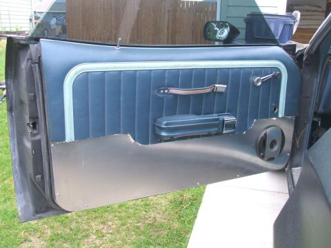 1974 Ford Ranchero - Interior view of a car door panel, showing the blue fabric and chrome accents.