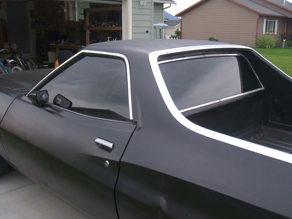 1974 Ford Ranchero side view, black paint, chrome trim around windows