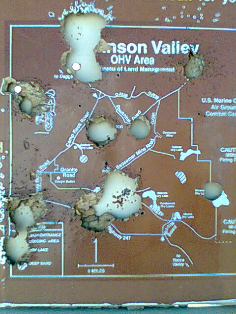 1978 Jeep Cherokee - A map of the Johnson Valley OHV Area is heavily damaged by bullet holes.