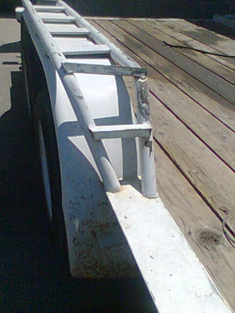 1978 Jeep Cherokee - A white metal ramp for a trailer is shown with a wooden deck.