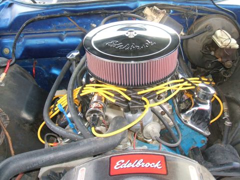 1974 Ford Ranchero - Close-up view of a modified engine bay, an Edelbrock air cleaner and chrome valve covers.