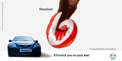 2003 Mazda 6 - A blue Mazda 6 is shown from the front, with a boxing glove poised to strike.