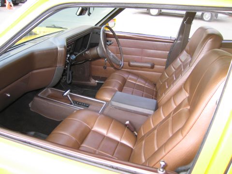 1991 Ford LTD Crown Victoria - brown tufted vinyl front and rear seats and dashboard interior of a classic two-door car.