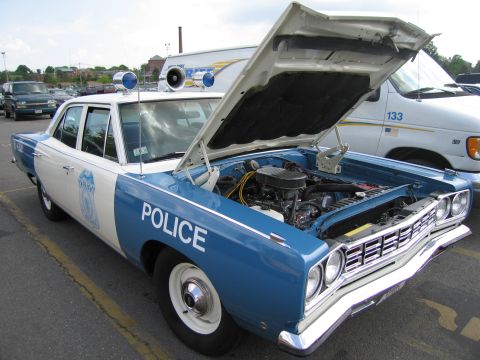 1991 Ford LTD Crown Victoria - blue and white vintage Police sedan with the hood open revealing the engine bay, parked at a show.