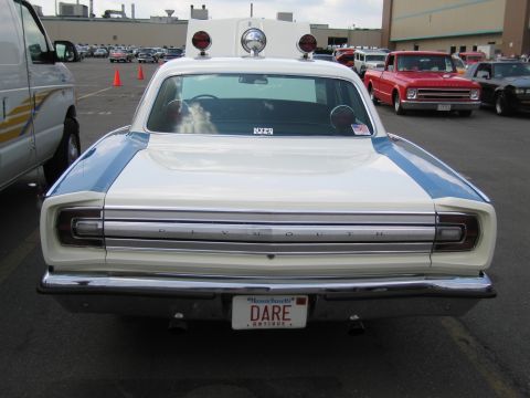 1991 Ford LTD Crown Victoria - Rear view of a white Plymouth sedan with roof emergency lights and a Massachusetts DARE license plate.