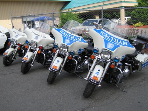 1991 Ford LTD Crown Victoria - row of white and blue police touring motorcycles with windshields lettered Waltham and Framingham, numbered 1 through 4.