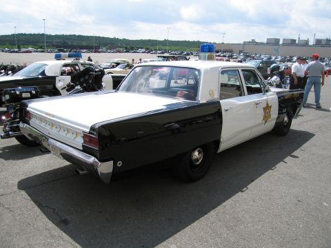 1991 Ford LTD Crown Victoria - Rear three-quarter view of a black and white Deputy Sheriff sedan with roof lights in a crowded show parking lot.