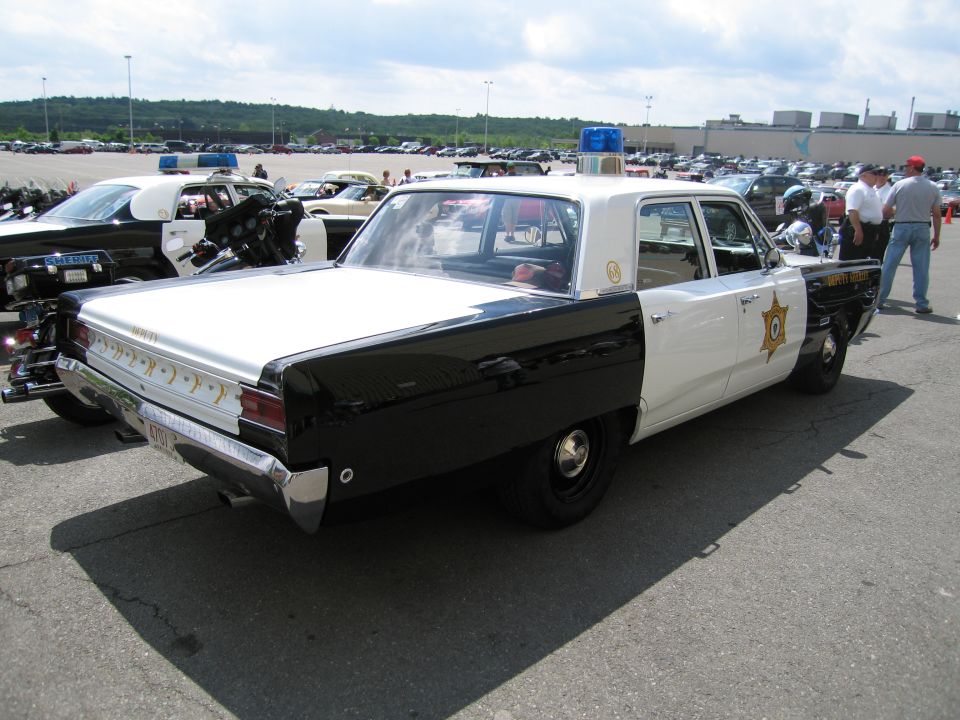 Rear three-quarter of black and white Deputy Sheriff sedan