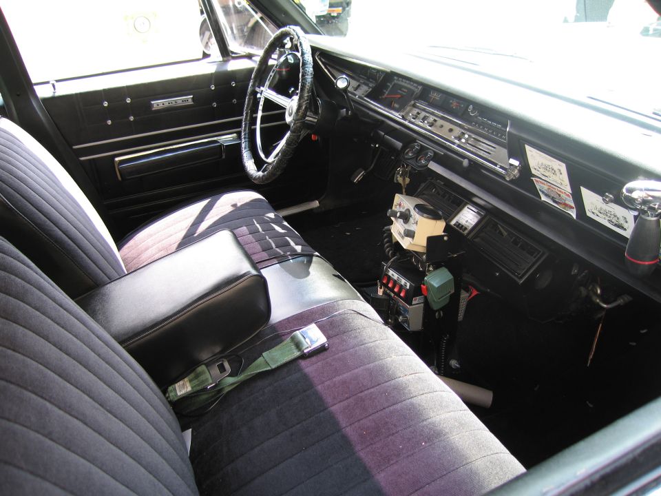 Interior of a classic sedan with police radio and CB equipment