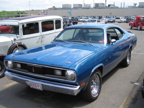 1991 Ford LTD Crown Victoria - Photograph of a blue Plymouth Duster at an outdoor car show, not a technical document.