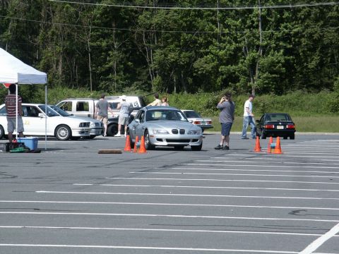 2001 Mercury Grand Marquis - Photograph of cars, a silver BMW Z3 and others, staged at an autocross event in a coned parking lot.