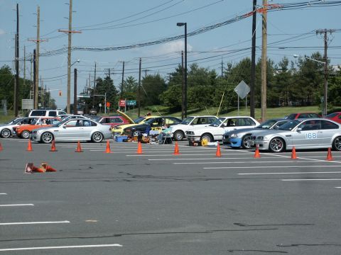 2001 Mercury Grand Marquis - Photograph of numbered cars including BMWs lined up along an orange-coned autocross course in a parking lot.