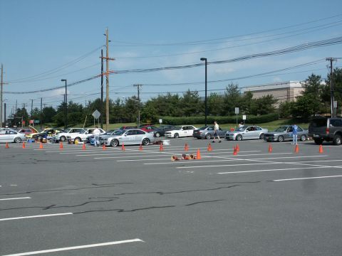 2001 Mercury Grand Marquis - Photograph of cars staged along a coned autocross course in a large open parking lot.