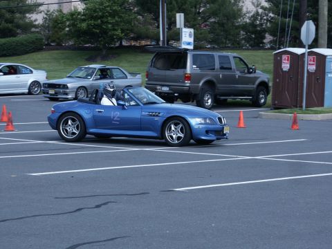2001 Mercury Grand Marquis - Photograph of a blue BMW Z3 roadster numbered 12 driving an orange-coned autocross course in a parking lot.
