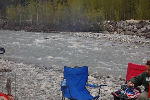 1978 Ford Bronco - A scenic view of a river with camping chairs set up on the rocky bank.