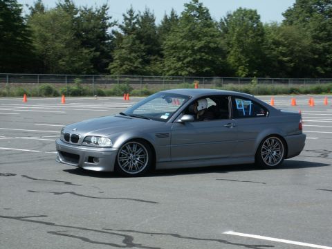 2001 Mercury Grand Marquis - Photo of a gray BMW E46 M3 coupe at an autocross, cones and trees in the background.